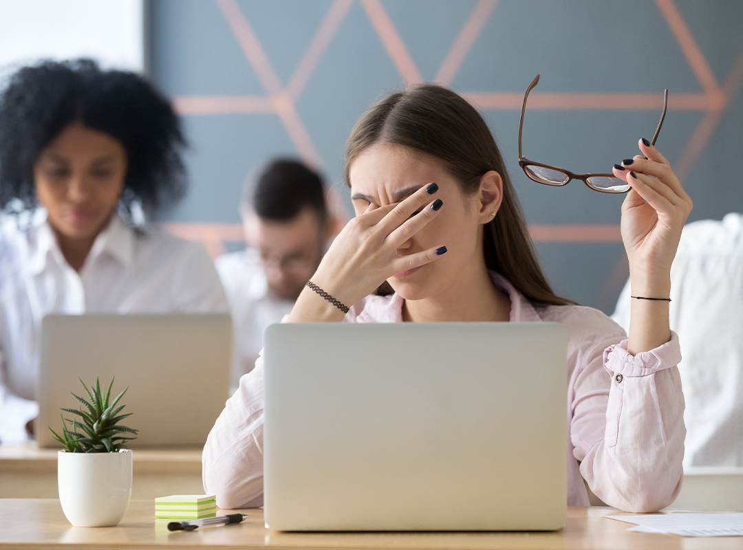 Person looking at a computer screen with eye strain