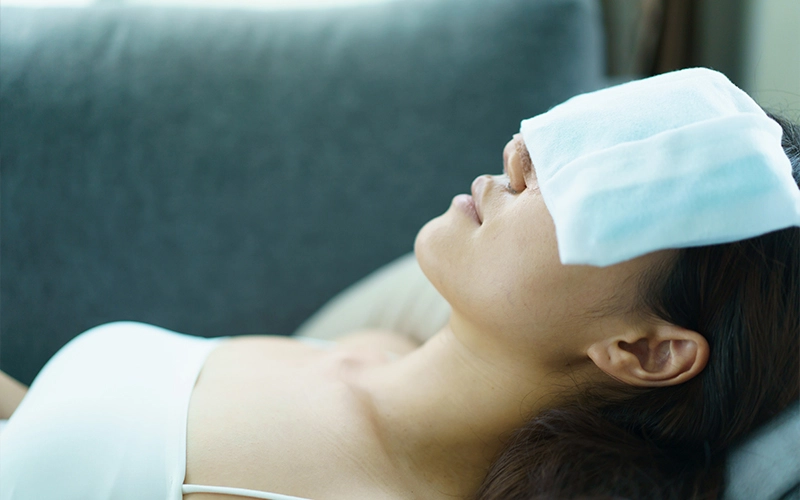 Applying a warm compress over closed eyelids as a first step for stye or chalazion home care