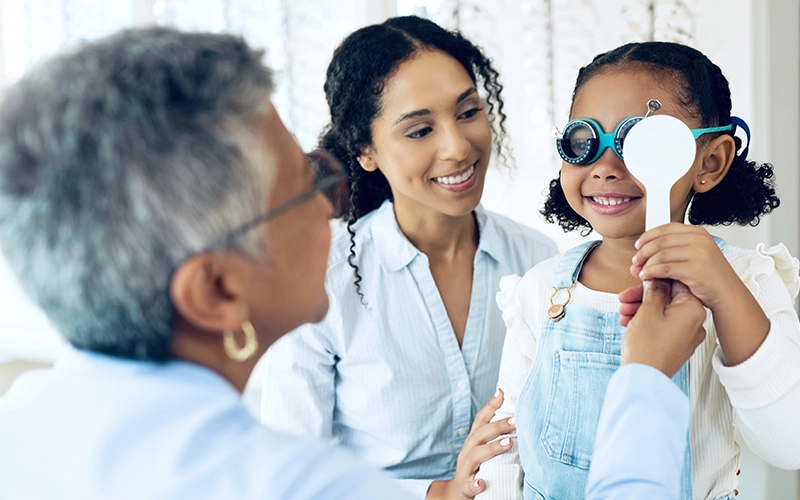Child undergoing pediatric eye examination for myopia control at HARINA Optométristes in Montreal