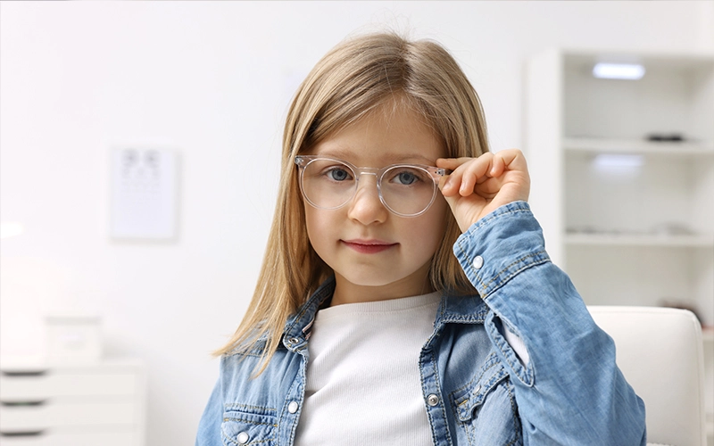 Child wearing glasses for myopia control evaluation at HARINA Optométristes in Montreal